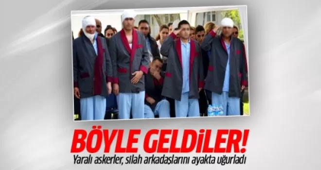Yaralı askerler, silah arkadaşlarını ayakta uğurladı